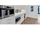 A well-appointed kitchen boasts an integrated coffee maker, wine fridge, stainless oven, and herringbone backsplash at 102 Grand Cres, Alpharetta, GA 30009