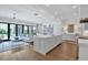A modern kitchen is open to the living and dining area, and boasts a large island and stainless appliances at 102 Grand Cres, Alpharetta, GA 30009