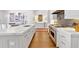 A modern kitchen features a large center island, stainless steel appliances, and is open to the living room at 102 Grand Cres, Alpharetta, GA 30009
