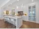 A bright, modern kitchen features a large center island with seating and stainless steel appliances at 102 Grand Cres, Alpharetta, GA 30009