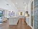 A modern kitchen boasts a large island, stainless steel appliances, and is open to the dining and living areas at 102 Grand Cres, Alpharetta, GA 30009