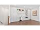 A charming kitchenette with shaker cabinets, stainless steel appliances, floating shelves, and white backsplash is well-lit at 102 Grand Cres, Alpharetta, GA 30009