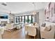 Open-concept living room with stylish decor, fireplace, and access to the outdoor patio at 102 Grand Cres, Alpharetta, GA 30009