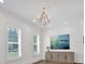Light-filled living room features hardwood floors, plantation shutters, and modern chandelier at 102 Grand Cres, Alpharetta, GA 30009
