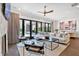 Bright living room featuring floor-to-ceiling glass doors, hardwood flooring, and a stylish ceiling fan at 102 Grand Cres, Alpharetta, GA 30009