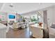 Open-concept living room with stylish decor, fireplace, and access to the outdoor patio at 102 Grand Cres, Alpharetta, GA 30009