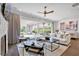 Bright living room featuring floor-to-ceiling glass doors, hardwood flooring, and a stylish ceiling fan at 102 Grand Cres, Alpharetta, GA 30009