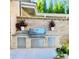 Outdoor kitchen with a stainless steel gas grill and brick surround, perfect for outdoor entertaining at 102 Grand Cres, Alpharetta, GA 30009