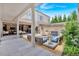 Beautiful outdoor patio with a fire pit, lounge seating, and a view of the adjacent living room at 102 Grand Cres, Alpharetta, GA 30009