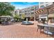 Charming outdoor seating area with tables, chairs, umbrellas, fountain, and beautiful landscaping at 102 Grand Cres, Alpharetta, GA 30009