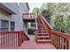 This is the back deck with stairs leading down to the back yard with trees at 1301 Dayspring Trce, Lawrenceville, GA 30045