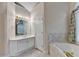 Bathroom features a large vanity, soaking tub, and tile flooring at 1301 Dayspring Trce, Lawrenceville, GA 30045