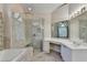 Elegant bathroom features a large vanity, soaking tub, and glass-enclosed shower at 1301 Dayspring Trce, Lawrenceville, GA 30045