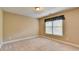 Neutral bedroom with carpet, window, and simple window treatment at 1301 Dayspring Trce, Lawrenceville, GA 30045