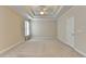 Spacious bedroom features a trey ceiling with ceiling fan and neutral carpeting at 1301 Dayspring Trce, Lawrenceville, GA 30045