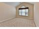 Bright bedroom with neutral walls, plush carpet, and a large window with natural light at 1301 Dayspring Trce, Lawrenceville, GA 30045