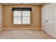 Neutral bedroom with carpet, closet, and a simple window treatment at 1301 Dayspring Trce, Lawrenceville, GA 30045