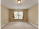 Bare bedroom with neutral walls, plush carpet, base trim, standard window, and overhead lighting at 1301 Dayspring Trce, Lawrenceville, GA 30045