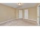 Neutral bedroom with plush carpet, base trim, two standard windows and two closets at 1301 Dayspring Trce, Lawrenceville, GA 30045