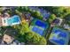 Aerial view of community amenities including pool, tennis courts, playground, and parking at 1301 Dayspring Trce, Lawrenceville, GA 30045