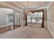 Formal dining room featuring a chandelier, wainscoting, and adjacent rooms with hardwood flooring at 1301 Dayspring Trce, Lawrenceville, GA 30045