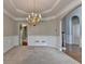 Spacious dining room featuring a chandelier, wainscoting, and access to other areas of the home at 1301 Dayspring Trce, Lawrenceville, GA 30045