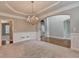 Dining room with chandelier, wainscoting detail, and hardwood floors leading into foyer and living room at 1301 Dayspring Trce, Lawrenceville, GA 30045