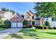 Charming two-story brick home with manicured landscaping, a two-car garage, and a beautiful lawn at 1301 Dayspring Trce, Lawrenceville, GA 30045