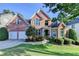 Beautiful two-story brick home with a well-manicured lawn and a two-car garage at 1301 Dayspring Trce, Lawrenceville, GA 30045