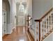 Bright foyer with hardwood floors, high ceilings, and staircase with carpeted steps at 1301 Dayspring Trce, Lawrenceville, GA 30045