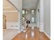 Spacious foyer with hardwood floors, a staircase, and views into a living room with fireplace at 1301 Dayspring Trce, Lawrenceville, GA 30045