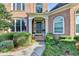 Inviting front entrance with a dark-colored door, manicured shrubbery, and stone walkway at 1301 Dayspring Trce, Lawrenceville, GA 30045