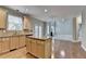 Kitchen with granite counters, wood cabinets, and island, open to living area with fireplace at 1301 Dayspring Trce, Lawrenceville, GA 30045