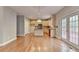 Bright kitchen with wood floors, an island, stainless appliances, and light wood cabinets at 1301 Dayspring Trce, Lawrenceville, GA 30045