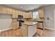 Well-lit kitchen with stainless appliances, a central island, and light wood cabinets offers a practical design at 1301 Dayspring Trce, Lawrenceville, GA 30045