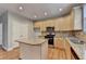 Bright kitchen with light wood cabinets, stainless appliances, and granite countertops at 1301 Dayspring Trce, Lawrenceville, GA 30045