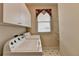 Functional laundry area equipped with a washer, dryer, and wire shelving at 1301 Dayspring Trce, Lawrenceville, GA 30045