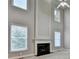 Living room with a fireplace, tall ceilings, and plenty of natural light at 1301 Dayspring Trce, Lawrenceville, GA 30045