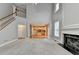 Bright living room with fireplace and staircase, leading to a kitchen with light cabinets at 1301 Dayspring Trce, Lawrenceville, GA 30045