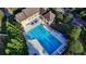 An aerial view shows the community pool with many lounge chairs surrounding it at 1301 Dayspring Trce, Lawrenceville, GA 30045