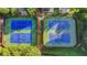 Aerial view of four well-maintained blue and green tennis courts surrounded by trees at 1301 Dayspring Trce, Lawrenceville, GA 30045
