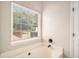Bright bathroom features a soaking tub with sleek fixtures and natural light at 215 Nina Circle Cir, Locust Grove, GA 30248