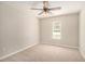 Bedroom with neutral walls, carpet flooring, a ceiling fan, and a window bringing in natural light at 215 Nina Circle Cir, Locust Grove, GA 30248
