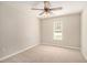 Cozy bedroom with neutral carpet, a ceiling fan, and a sunlit window at 215 Nina Circle Cir, Locust Grove, GA 30248