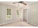 Bedroom with neutral carpet and walls, open closet space, and view to the landscaped exterior at 215 Nina Circle Cir, Locust Grove, GA 30248