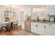Well-lit kitchen with stainless steel appliances, granite countertops, and a cozy breakfast nook at 215 Nina Circle Cir, Locust Grove, GA 30248
