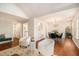 Open-concept living area showcasing hardwood floors, contemporary furnishings, and seamless flow to dining space at 215 Nina Circle Cir, Locust Grove, GA 30248