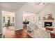 Bright living room featuring a cozy fireplace, vaulted ceiling, and hardwood floors at 215 Nina Circle Cir, Locust Grove, GA 30248