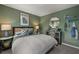This charming bedroom features soft green walls and trendy decor for a cozy, personalized space at 216 Paisley Way, Locust Grove, GA 30248