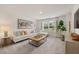 Comfortable living room featuring stylish furniture and a large window with natural light at 216 Paisley Way, Locust Grove, GA 30248
